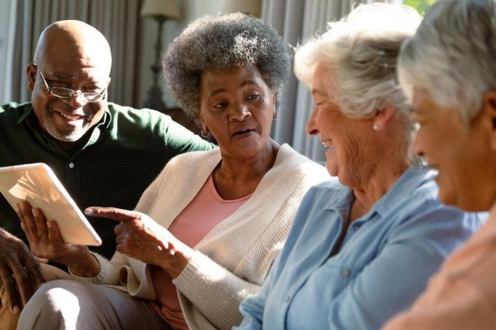 group of four older adults on a couch