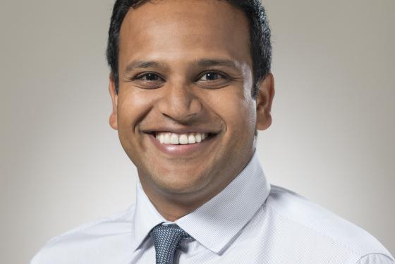 Austin Kilaru smiling in shirt and tie