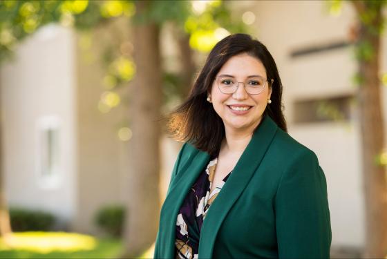Paula Villescaz smiling wearing a suit