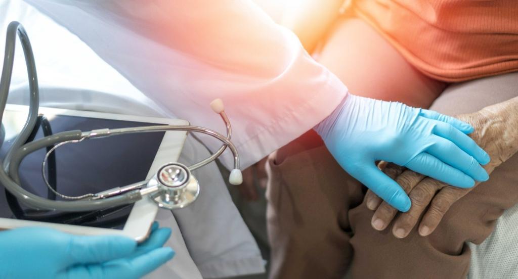 Doctor and patient being comforted close up hands