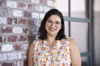 Paula Villacruz standing in front of wall